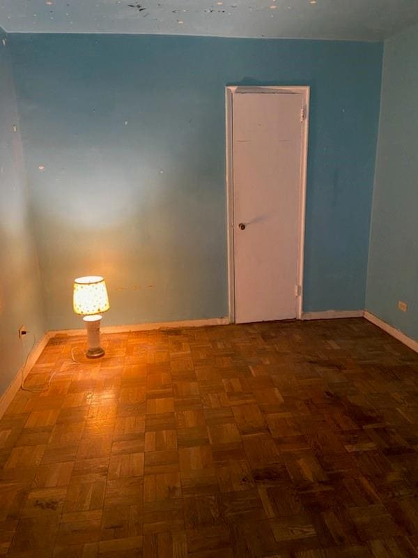 unfurnished room featuring parquet floors