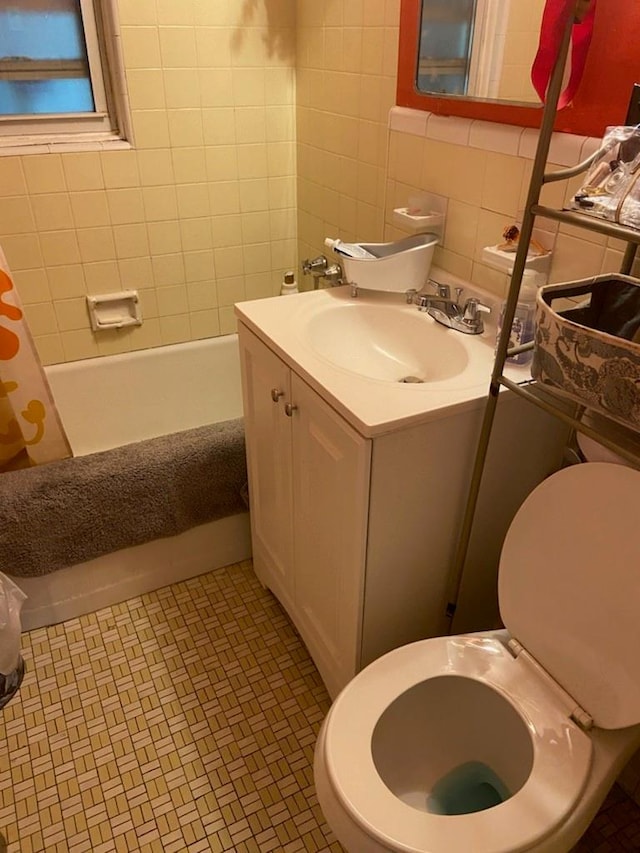 full bathroom featuring tile patterned floors, backsplash, tile walls, vanity, and shower / tub combo