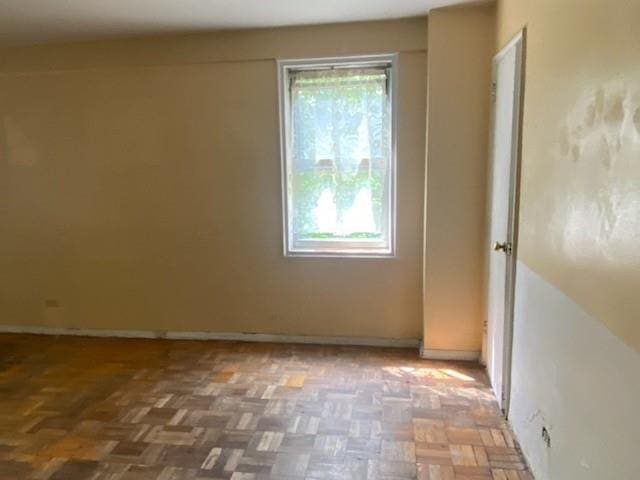 empty room featuring parquet flooring