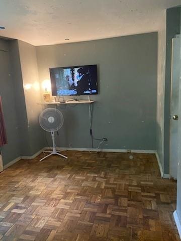 laundry area with dark parquet floors