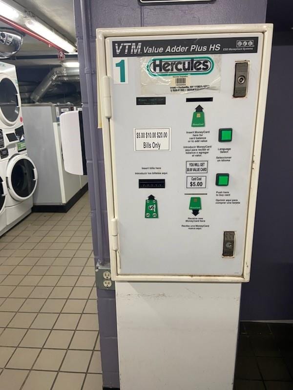 utility room featuring stacked washer / dryer