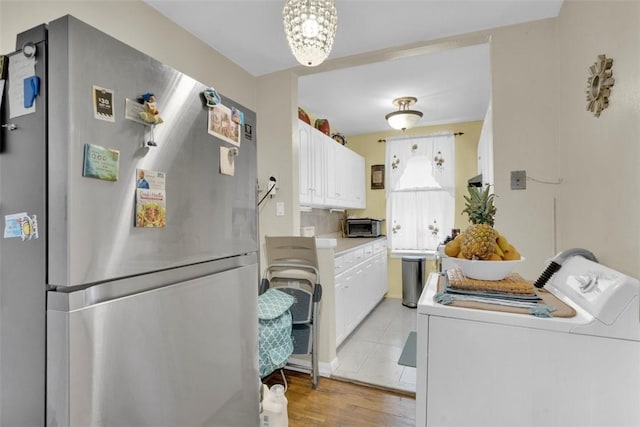 3231 Barker Ave Unit 1A, Bronx, NY 10467 - kitchen with freestanding refrigerator, white cabinetry, light countertops, and light wood-style flooring