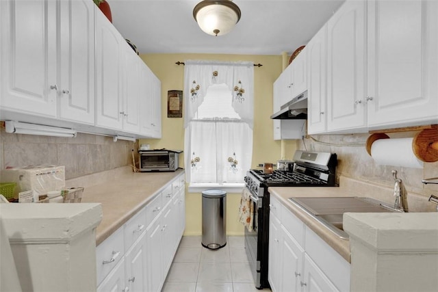 3231 Barker Ave Unit 1A, Bronx, NY 10467 - kitchen featuring stainless steel gas range, under cabinet range hood, white cabinetry, and light countertops