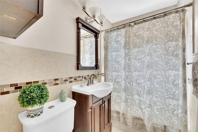 bathroom featuring vanity, curtained shower, toilet, and tile walls