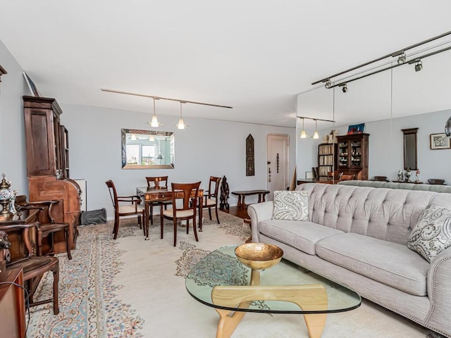 carpeted living room featuring track lighting