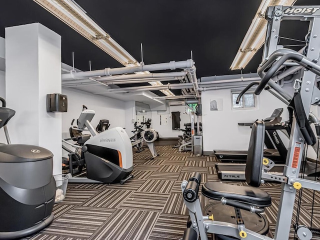 gym featuring dark colored carpet