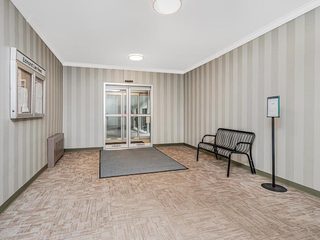 living area with radiator heating unit, light parquet floors, and ornamental molding