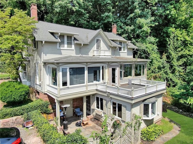 view of front facade with a balcony and a patio area