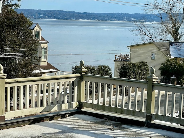 wooden terrace featuring a water view