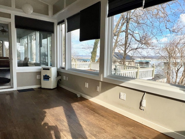 unfurnished sunroom with a water view