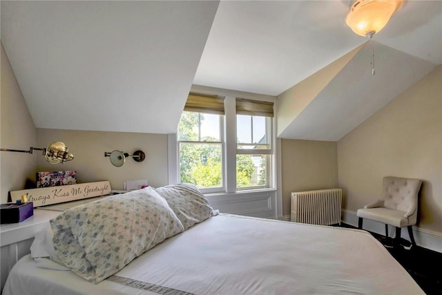 bedroom featuring vaulted ceiling and radiator heating unit