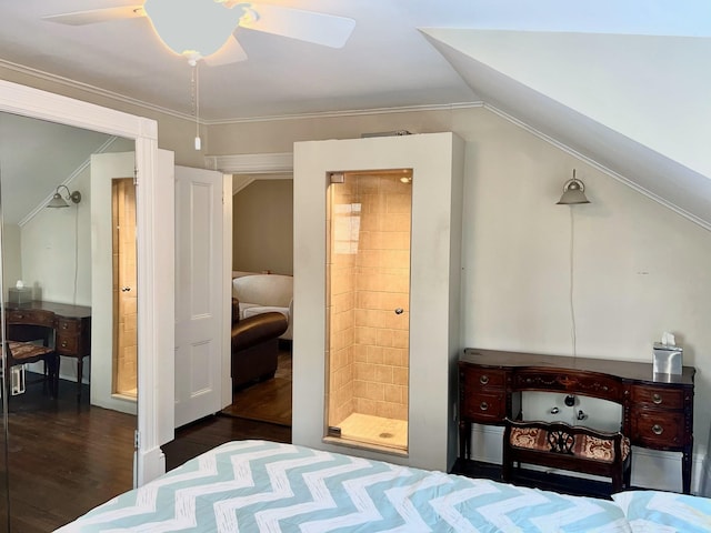 bedroom featuring lofted ceiling, connected bathroom, dark wood-type flooring, and ceiling fan