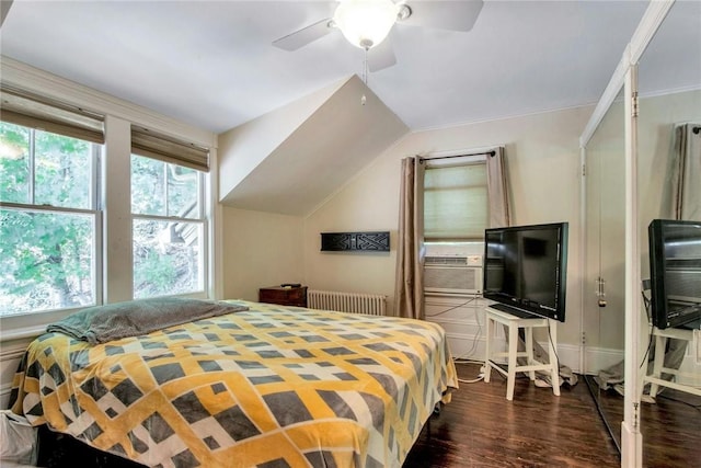 bedroom featuring lofted ceiling, radiator, ceiling fan, cooling unit, and dark hardwood / wood-style flooring