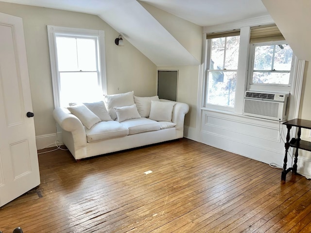 unfurnished living room with cooling unit, hardwood / wood-style flooring, and lofted ceiling