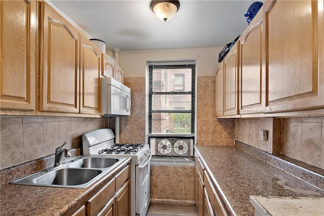 kitchen featuring decorative backsplash, wood-type flooring, sink, and stainless steel gas range