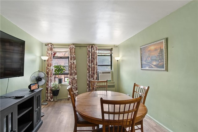 dining area featuring light hardwood / wood-style flooring and cooling unit