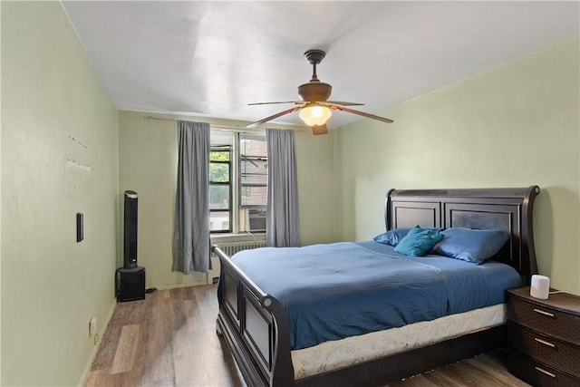 bedroom with ceiling fan and light hardwood / wood-style floors