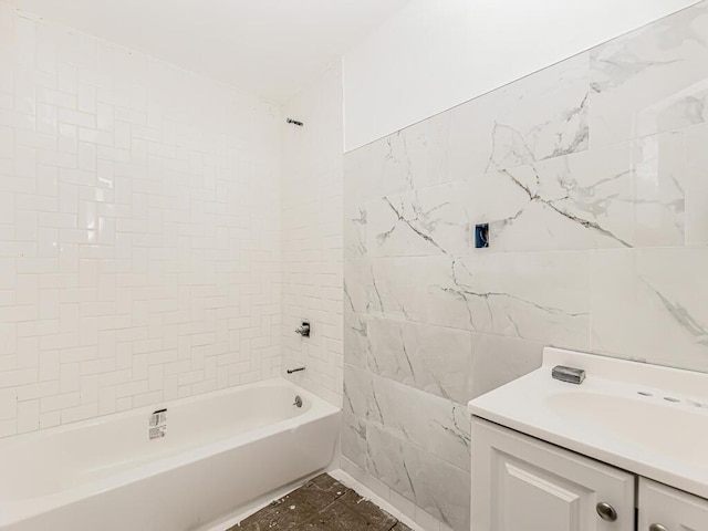 bathroom with tiled shower / bath combo and vanity