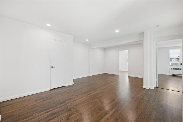 interior space with radiator heating unit and dark wood-type flooring