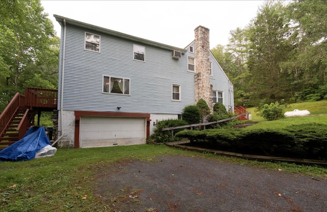 view of home's exterior with a garage and a wooden deck