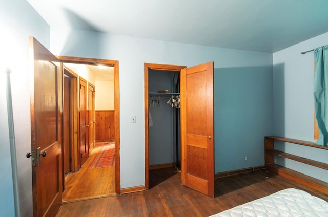 bedroom featuring dark hardwood / wood-style floors and a closet