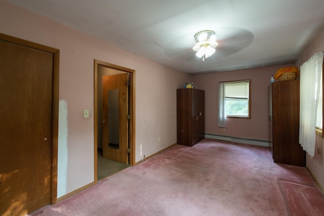 unfurnished bedroom with baseboard heating, ceiling fan, a closet, and light colored carpet