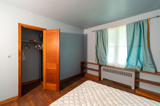 unfurnished bedroom with radiator, a closet, and wood-type flooring