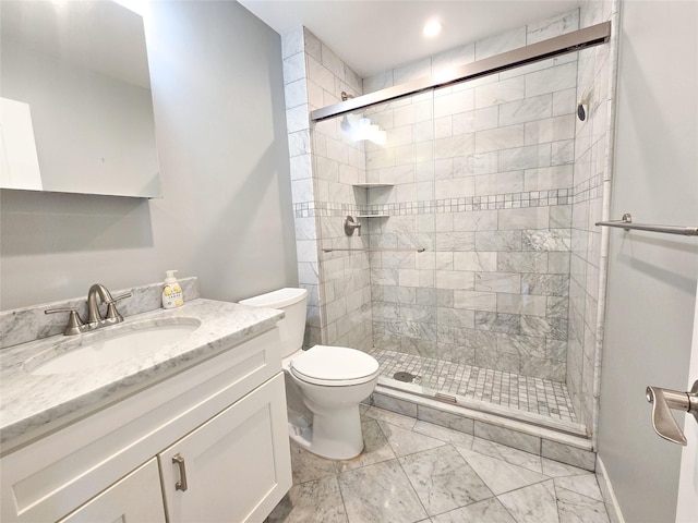 bathroom featuring toilet, walk in shower, and vanity