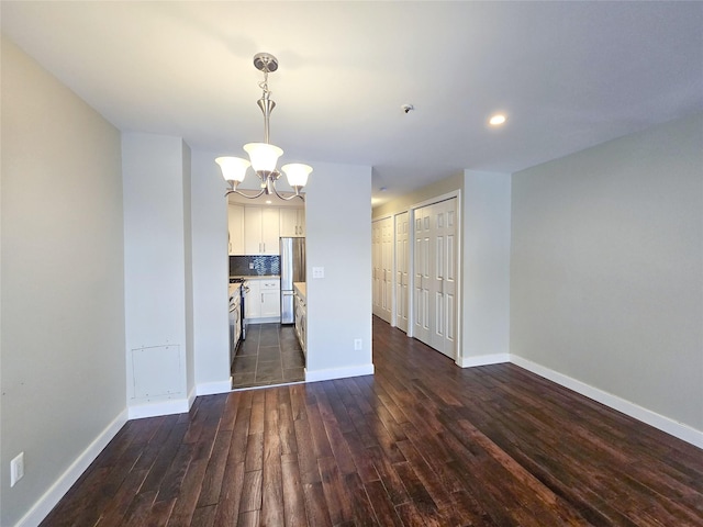 interior space featuring dark wood-type flooring and a notable chandelier