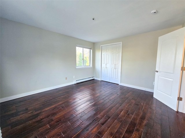 unfurnished bedroom with a closet, dark hardwood / wood-style flooring, and a baseboard radiator