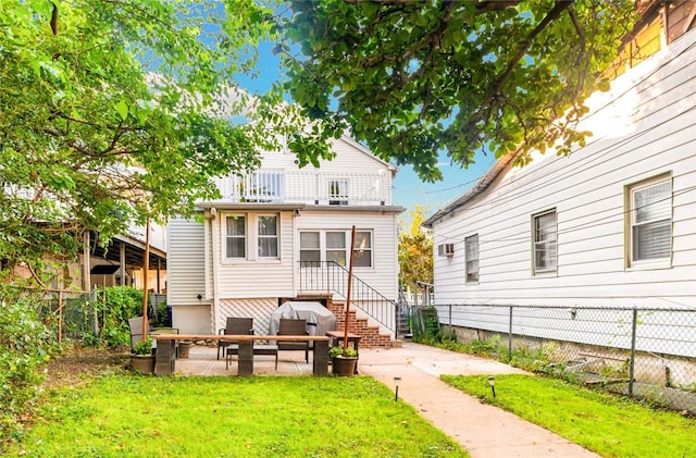 back of property featuring a patio area and a yard