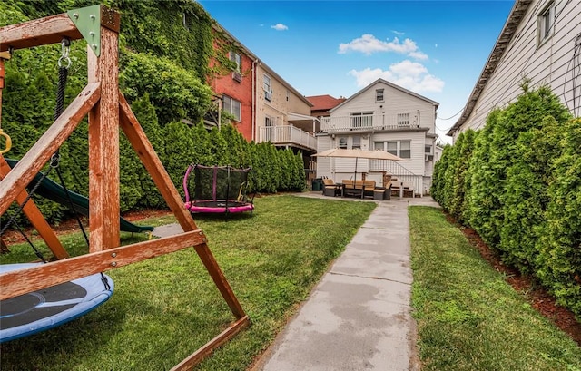 view of yard featuring a patio and a trampoline