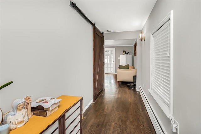 hallway featuring dark hardwood / wood-style flooring, a barn door, and a baseboard heating unit