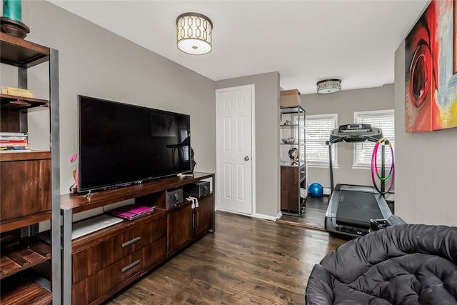 workout area with dark wood-type flooring