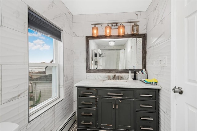 bathroom featuring vanity and tile walls