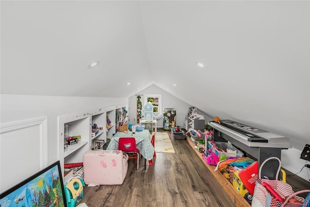 recreation room featuring dark hardwood / wood-style flooring and lofted ceiling