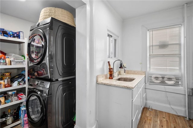 3026 Kingsland Ave, Bronx, NY 10469 - laundry area with stacked washer / drying machine, light wood-type flooring, and sink