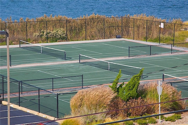 view of sport court featuring a water view