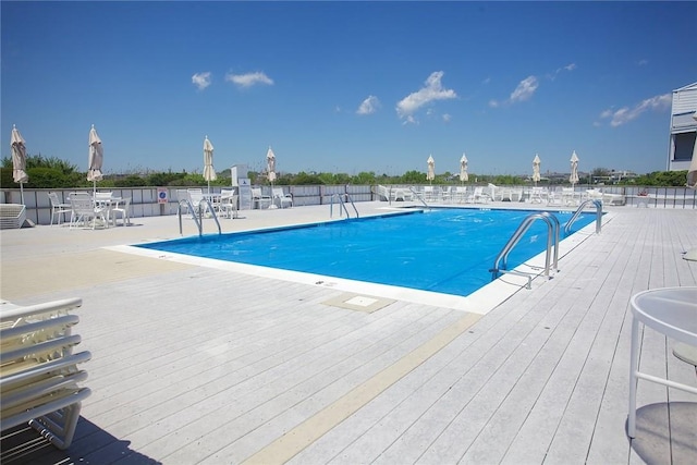 view of pool featuring a deck and a patio