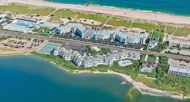 birds eye view of property with a water view and a view of the beach