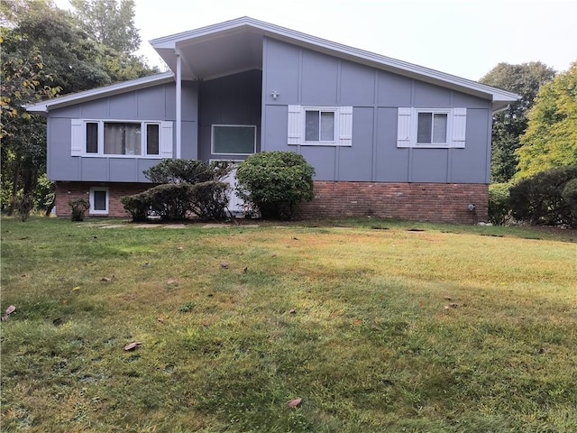 view of side of home with a yard