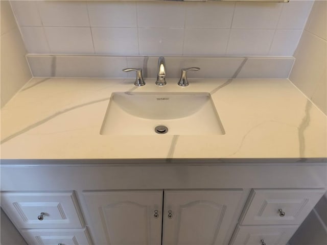 bathroom featuring tasteful backsplash and sink