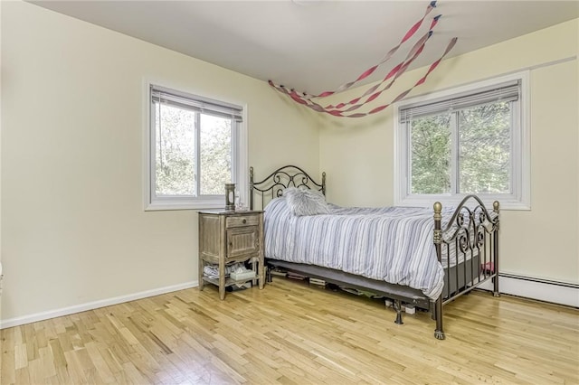 bedroom featuring multiple windows and hardwood / wood-style flooring