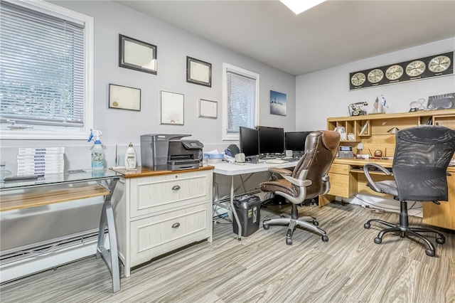 home office with light hardwood / wood-style flooring