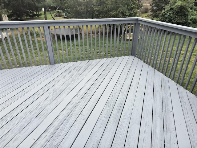 wooden deck with a lawn