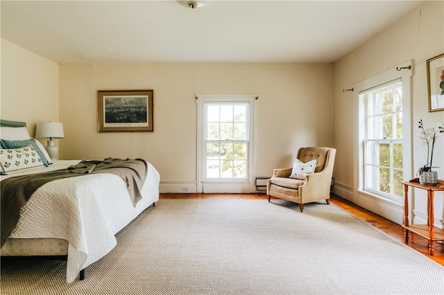 bedroom featuring hardwood / wood-style floors and multiple windows