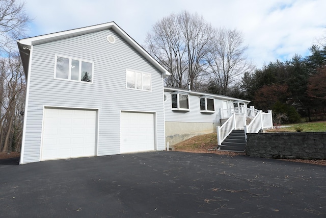 view of front of property featuring a garage and a deck