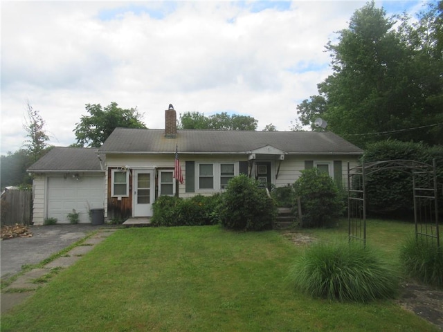 view of front of house featuring a front yard and a garage