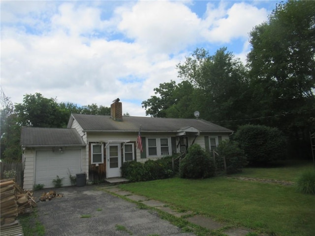 ranch-style house featuring a garage and a front lawn