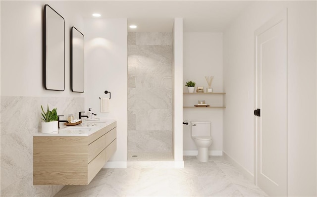 bathroom featuring a shower, vanity, toilet, and tile walls